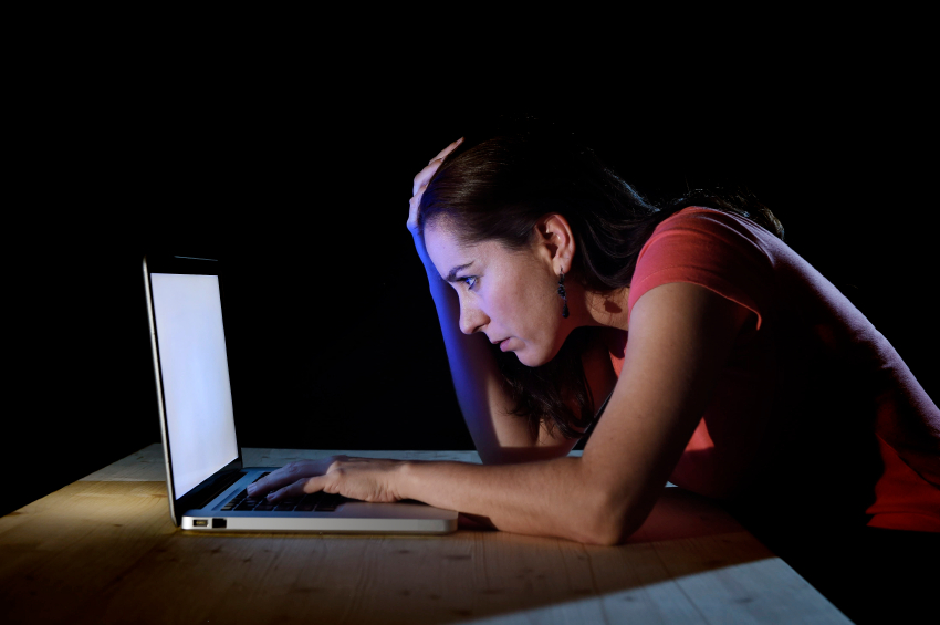 depressed worker or student woman working with computer alone late night in stress